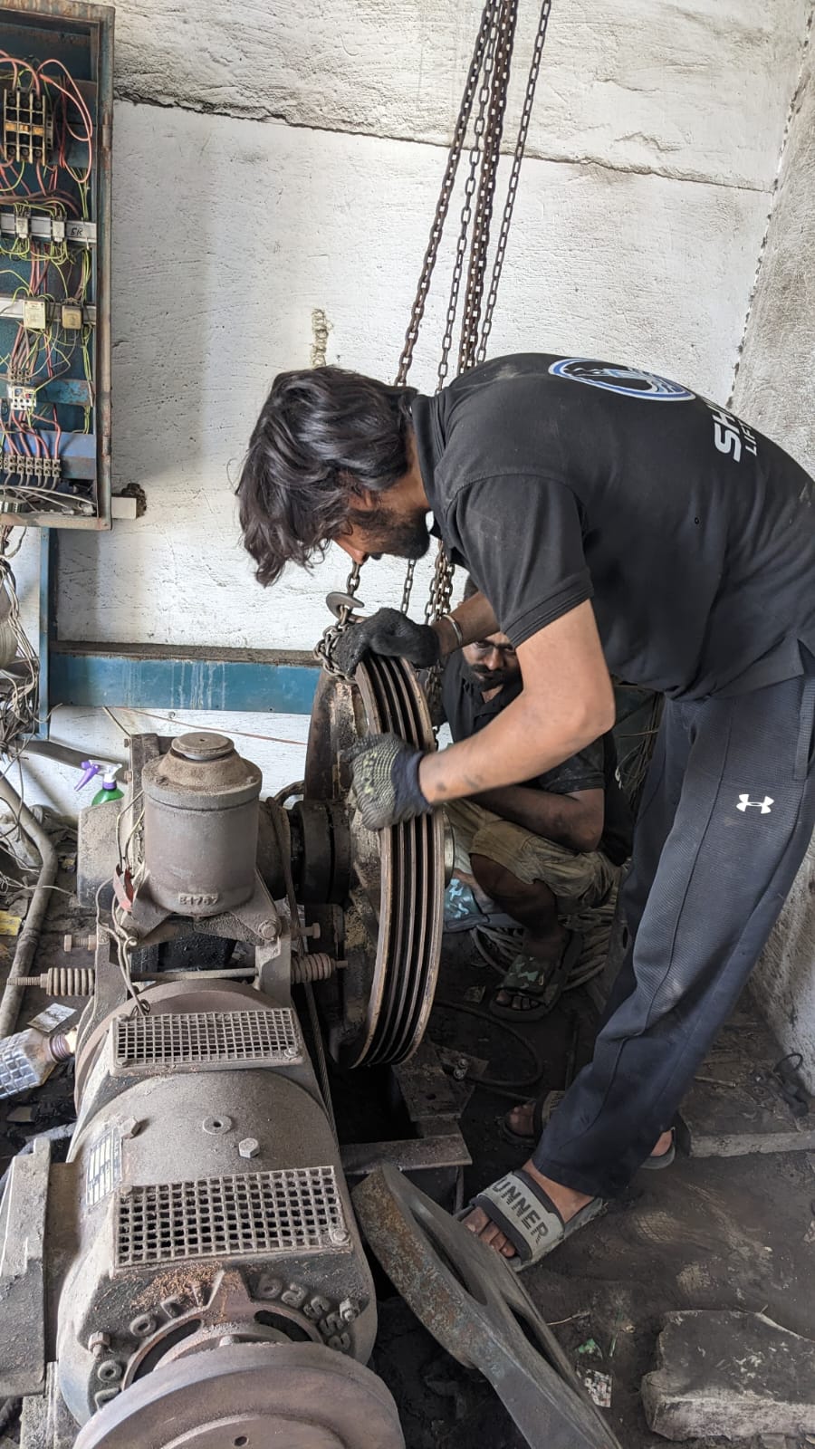 Shinkai technician working on lift machinery